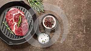 Fresh ribeye steak on a pan and spices