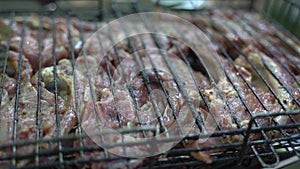 Fresh ribs of lamb meat on a grill. Slow motion