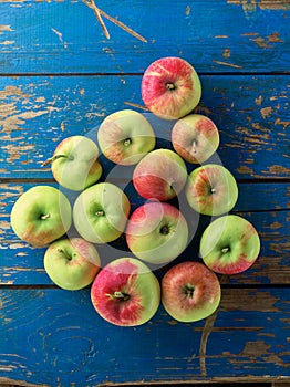 Fresh and ripe apple on blue table