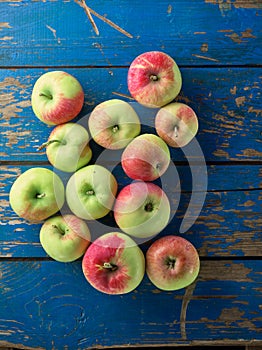 Fresh and ripe apple on blue wooden table