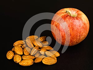 Fresh Ripe Apple With A Handful of Roasted Almond Nuts