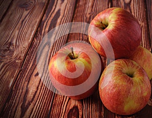 Fresh, ripe apples on an old wooden table. Fruit to comply with the diet