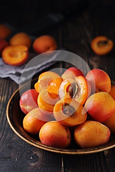 Fresh ripe apricots in bowl in rustic style