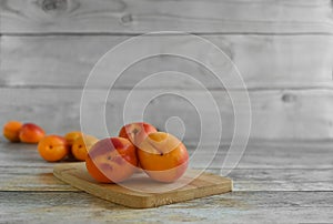 Fresh ripe apricots on a wooden table, copy space .