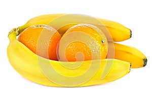 Fresh ripe bananas and orange fruits