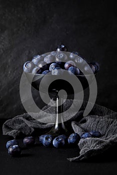 Fresh ripe blueberries on a napkin and slate plate kitchen table