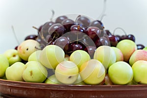 fresh ripe cherries and apricots closeup as background. beautiful fruit background