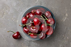 Fresh ripe cherries on grey table, flat lay