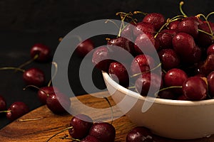 Fresh ripe cherries with water drops closeup dark photo