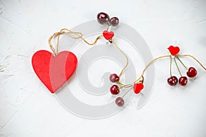 Fresh ripe cherry and red heart isolated on white background.Fit and healthy eating concept.Red color diet, heart health