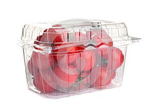Fresh ripe cherry tomatoes in plastic container on white background
