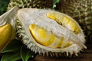 Fresh ripe durian fruits on wooden table, closeup