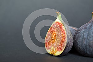 Fresh ripe figs on dark table. Healthy mediterranean fig fruit.