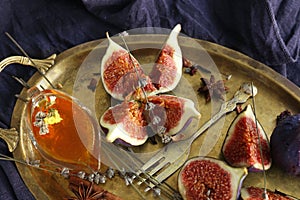 Fresh ripe figs with honey on metal tray