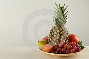 Fresh ripe fruits on white wooden table, space for text