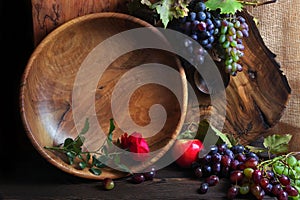 Fresh ripe grapes. Grape harvest. Handmade wooden utensils on the kitchen table. Wooden plates, bowls and dishes on the table.