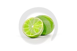 Fresh and ripe green lime whole and cut in half, vitamin rich fruit, exotic fruit isolated