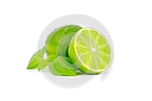 Fresh and ripe green lime whole and cut in half, vitamin rich fruit, exotic fruit isolated