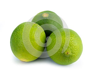 Fresh ripe green limes isolated on white background