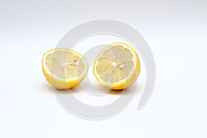 Fresh, ripe, isolated, juicy bisected lemon on a white background. Studio macro shoot