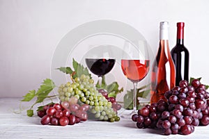 Fresh ripe juicy grapes and wine on wooden table
