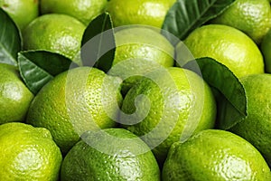 Fresh ripe juicy limes as background