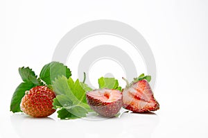 Fresh, ripe, juicy and mouth-watering strawberries with green leaves