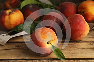 Fresh ripe juicy peaches on wooden table, closeup