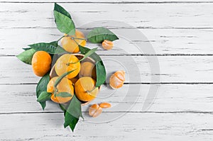 Fresh ripe juicy yellow mandarin  clementine, tangerine  on rustic vintage table with leaf