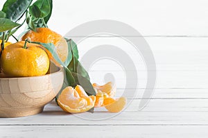 Fresh ripe juicy yellow mandarin  clementine, tangerine  on rustic vintage table with leaf