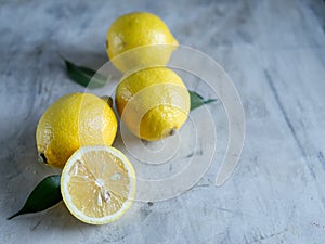 Fresh ripe lemons on grey stone background. Top view with copy space.