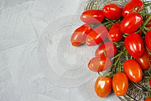 Fresh ripe mini marzano tomatoes on grey boards