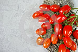 Fresh ripe mini marzano tomatoes on grey boards