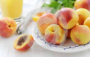 Fresh ripe nectarines on white wooden table