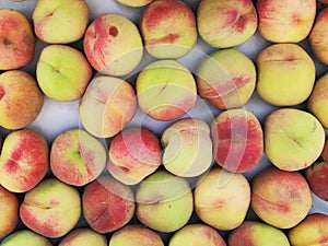 Fresh, ripe nectarines in wooden boxes for sale at a market. Close up. Fruit, summer concept