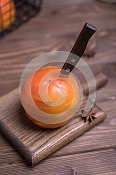 Fresh ripe, orange jucy persimmons cut into slices, close-up