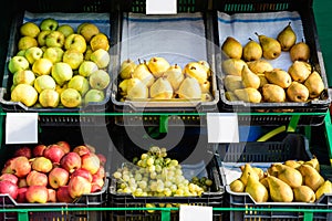 Fresh ripe organic fruits displayed for sale at a street food market in Bucharest, Romania, green and read apples, yellow pears an