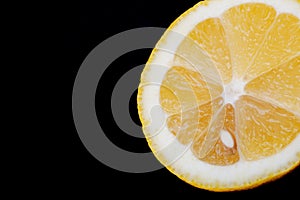 Fresh Ripe Organic Lemon cut in half isolated on black. Citrus Limon. Rutaceae family.