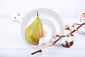 Fresh ripe organic pear on white wooden background