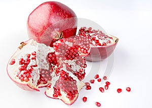 Fresh, ripe, organic pomegranate fruit on white background.