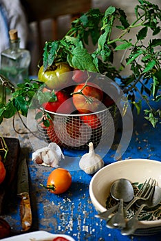 Fresh, ripe, organic tomatoes in an old basket. Rustic style