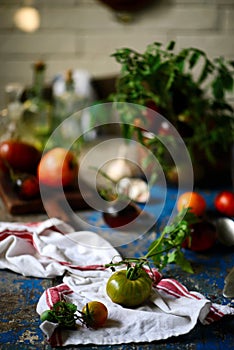 Fresh, ripe, organic tomatoes in an old basket. Rustic style