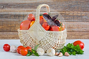 Fresh ripe organic tomatoes in a wicker basket