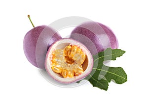 Fresh ripe passion fruits maracuyas with green leaf isolated