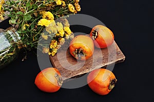 Fresh ripe persimmon on a black background . Persimmons fruit, Ripe sweet persimmons