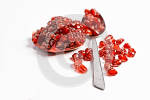 Fresh ripe pomegranate on white background, Spoon with fresh pomegranate seeds