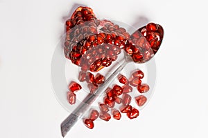 Fresh ripe pomegranate on white background, Spoon with fresh pomegranate seeds