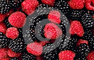 Fresh ripe raspberries and blackberries background