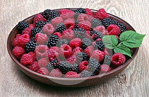 Fresh ripe raspberries and blackberries on a wooden table. summer healthy berries