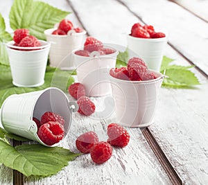 Fresh ripe raspberry in small bucket